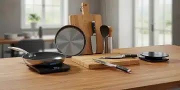 Utensílios de cozinha essenciais e duráveis em uma bancada moderna, incluindo panela de aço inoxidável, tábua de corte e faca afiada.