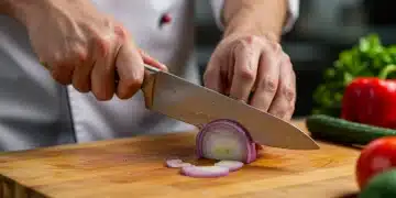 Chef dicing onion with sharp knife on cutting board