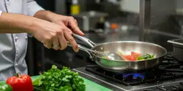 Chef sautéing vegetables in a pan, demonstrating expert cooking techniques.