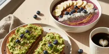 Variety of quick healthy breakfast items including a smoothie bowl, avocado toast, and coffee on a table.