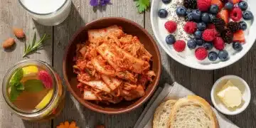 Assortment of probiotic-rich foods including kimchi, kombucha, yogurt, sourdough, and kefir.