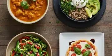 Four quick and easy meals prepared in under 20 minutes, ready to eat, on a wooden table.